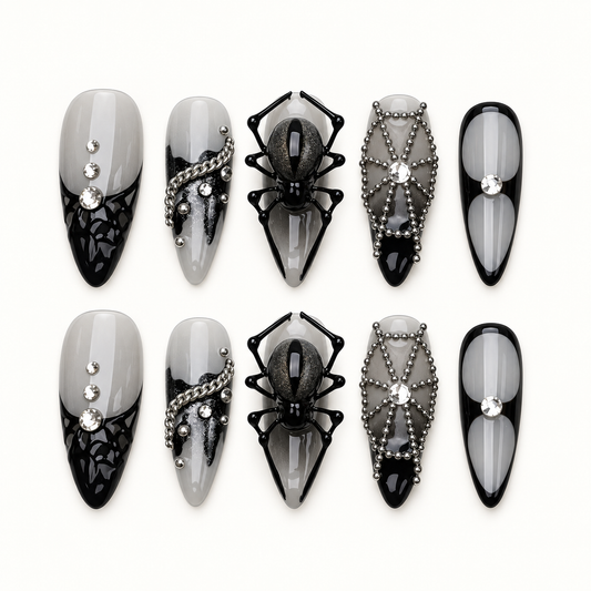 Midnight Web press-on nails in smoky gray and glossy black with dimensional spider, web, bead-chain, and crystal-inspired accents.