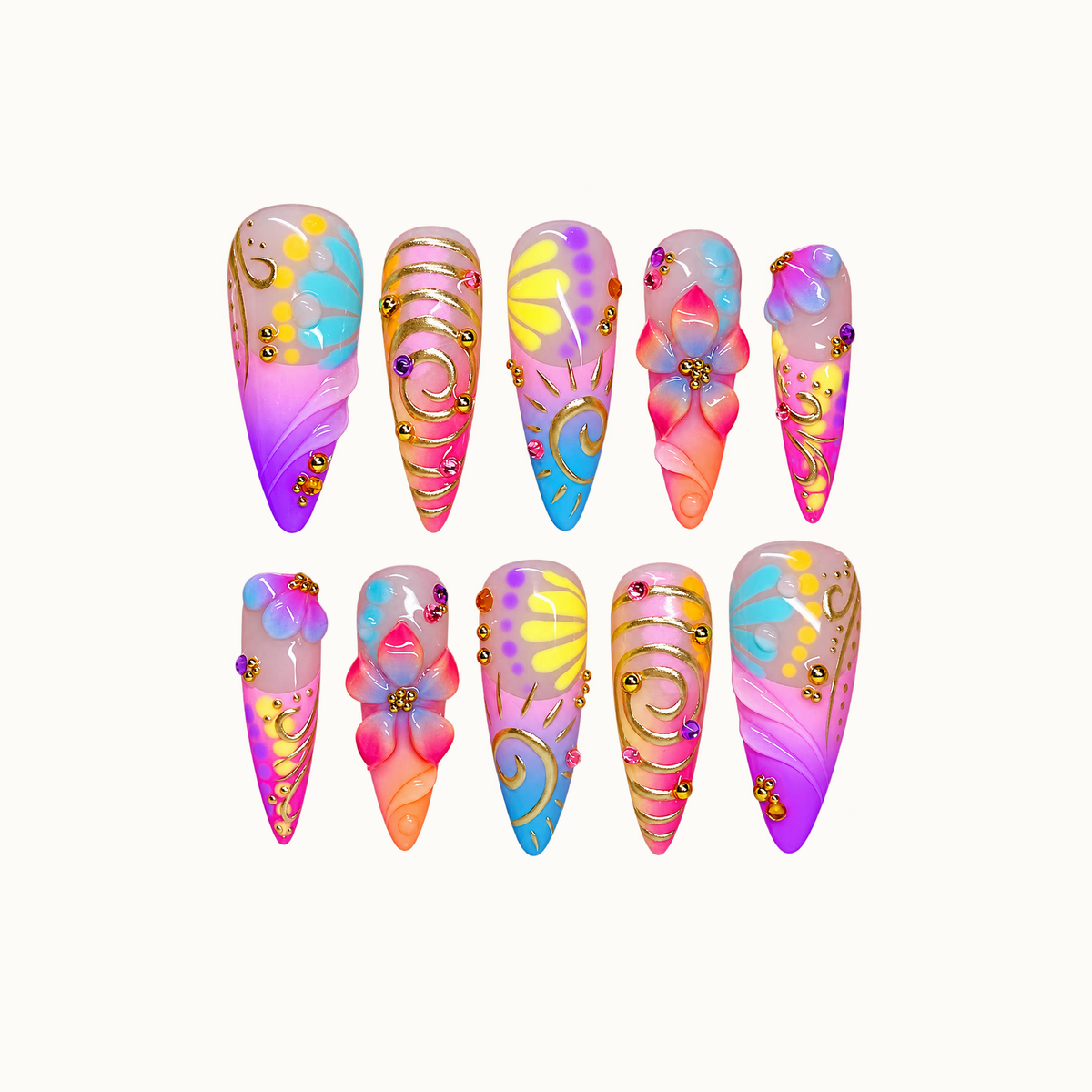 Ten coordinated multicolor nails arranged in two rows on a light neutral background, featuring raised flowers, gold-colored swirls, and bright pink, purple, blue, and yellow accents.