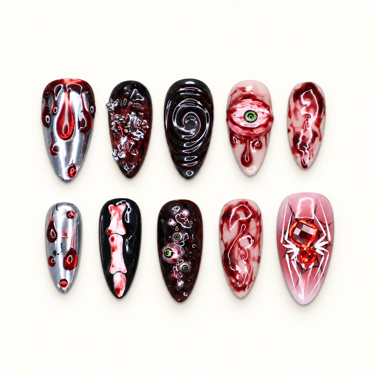 Ten glossy Halloween press-on nails in crimson red, black, pale pink, silver, white, and green with eyeball, drip, marbled, and sculpted designs.
