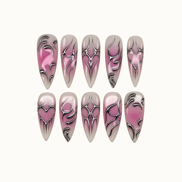 Ten glossy greige and mauve nails arranged in two rows, featuring silver chrome-look hearts, pointed diamond accents, and sweeping curves.