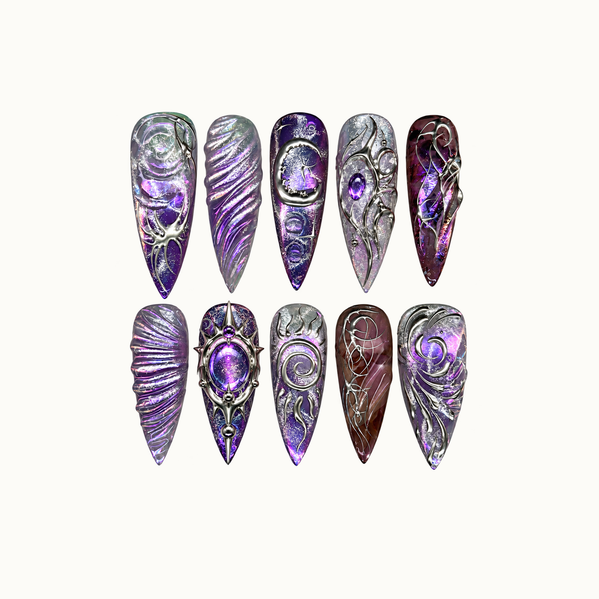 Ten pointed nails arranged in two rows on a light neutral background, featuring purple shimmer, silver scrollwork, spirals, and jewel-like accents.
