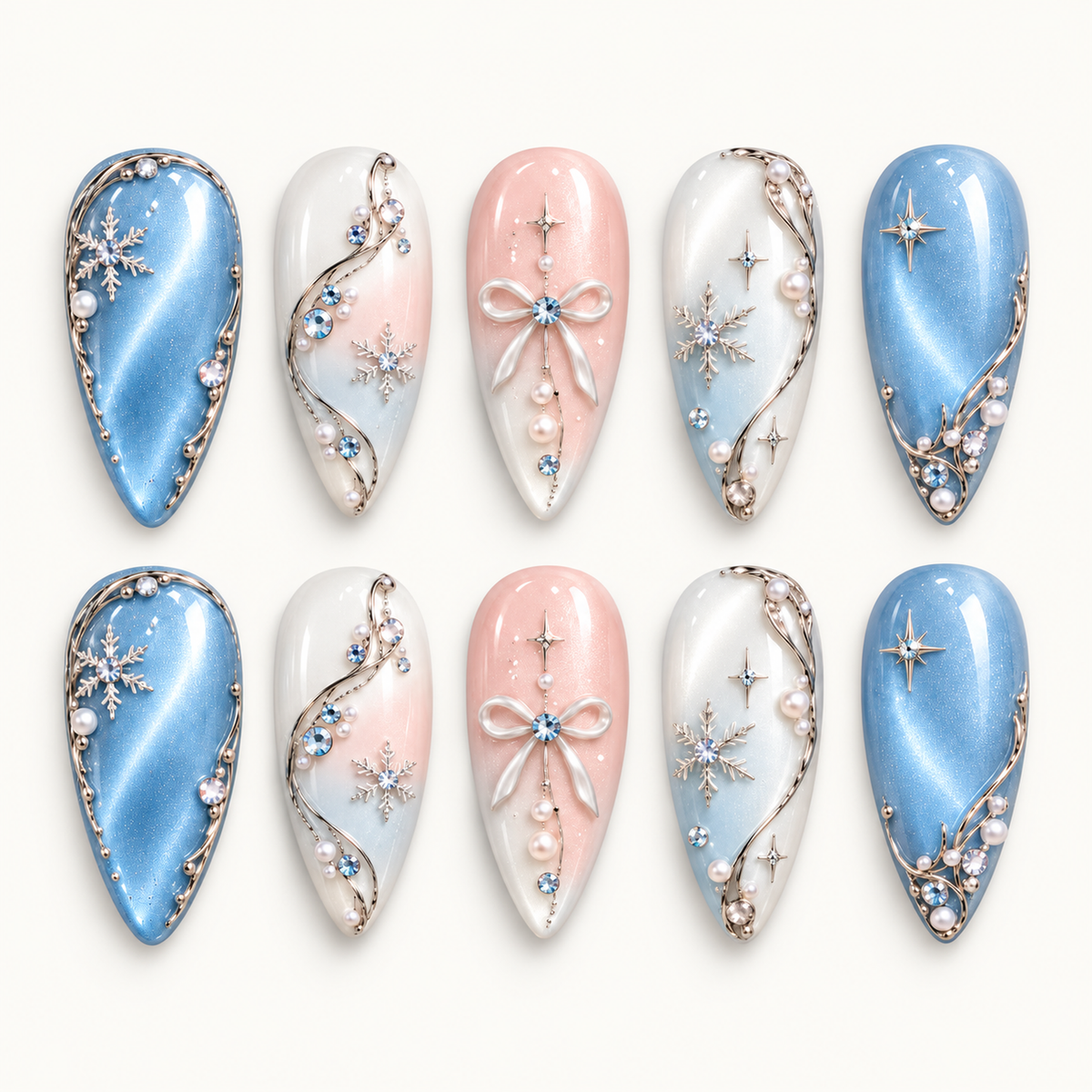 Ten coordinated nails arranged in two rows on a light neutral background, featuring blue shimmer, blush bows, snowflakes, and pearl-like accents.