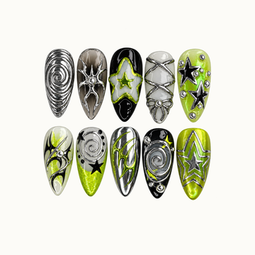 Ten lime, black, white, gray, and silver-toned nails arranged in two rows, featuring stars, spirals, abstract curves, and a bow.