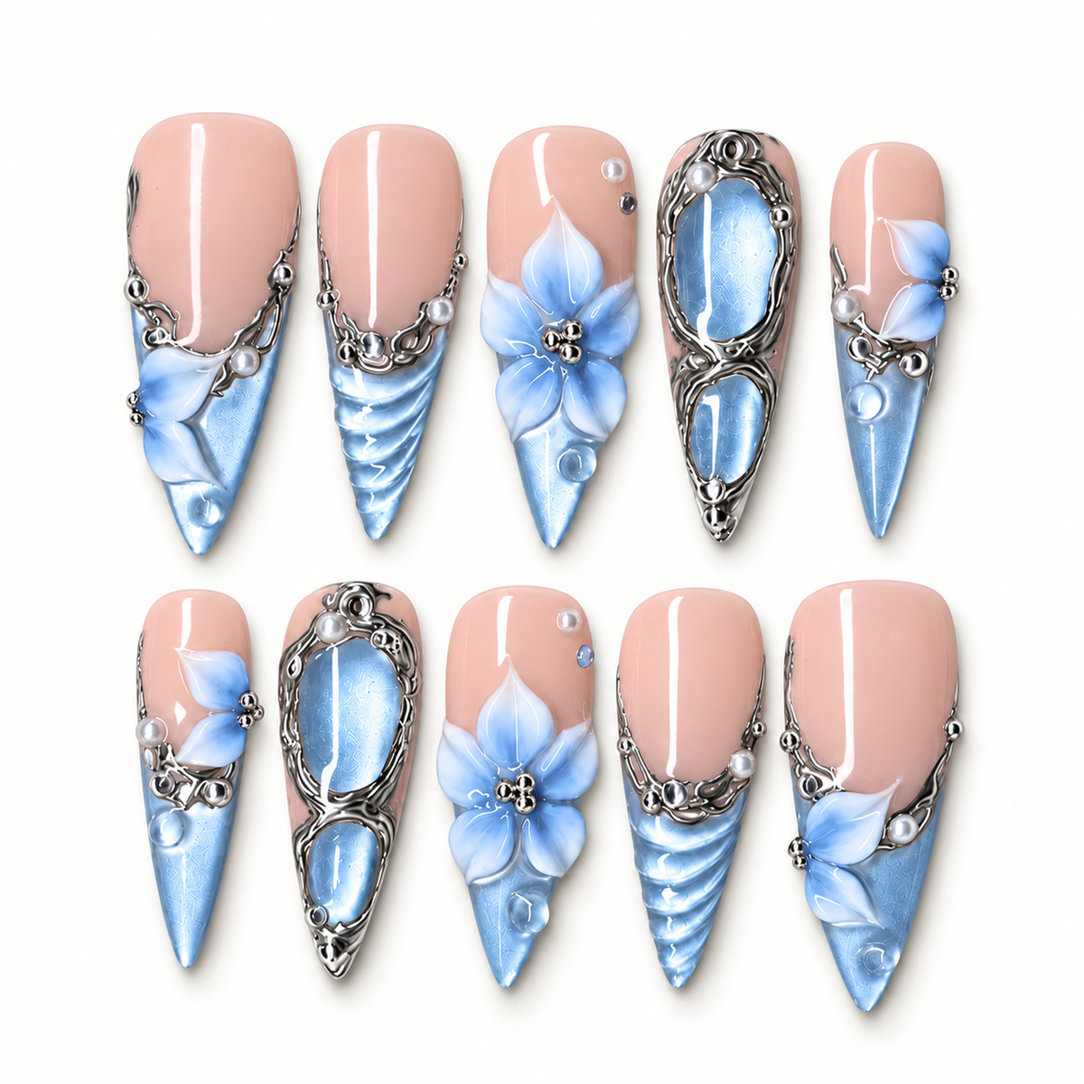 Ten coordinated press-on nails arranged in two rows on a light background, showing pink bases, blue pointed tips, blue flowers, silver-tone scrollwork, and pearl-like accents.