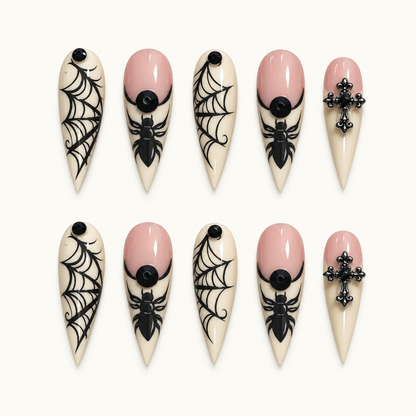 Midnight Web Cross press-on nail set with ivory tips, black spiderweb linework, spiders, black dots, and cross-shaped accents.
