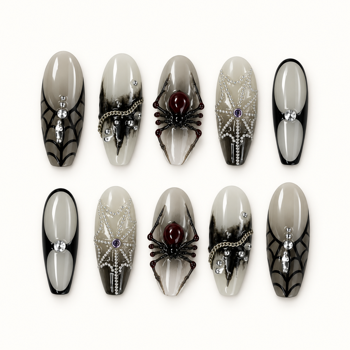 Ten glossy greige and smoky gray press-on nails arranged on a white surface, featuring black spider webs, dimensional spiders, silver beads, and crystal accents.
