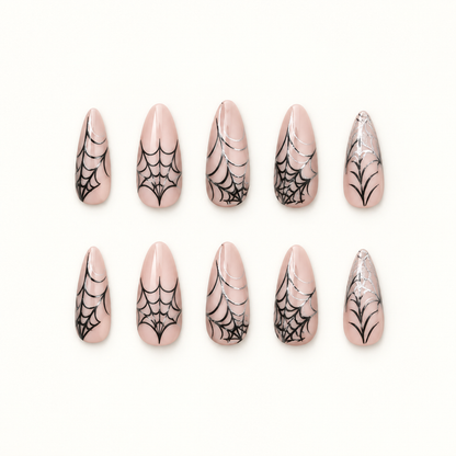 Midnight Webline press-on nails on a neutral background, showing nude bases, black spiderweb line art, and graphic tip accents.