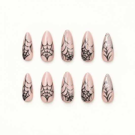 Midnight Webline press-on nails on a neutral background, showing nude bases, black spiderweb line art, and graphic tip accents.