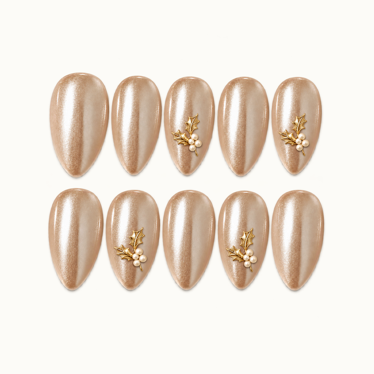Ten champagne shimmer nails arranged in two rows on a light neutral background, with gold-tone holly leaves and ivory pearl-like clusters on four accent nails.