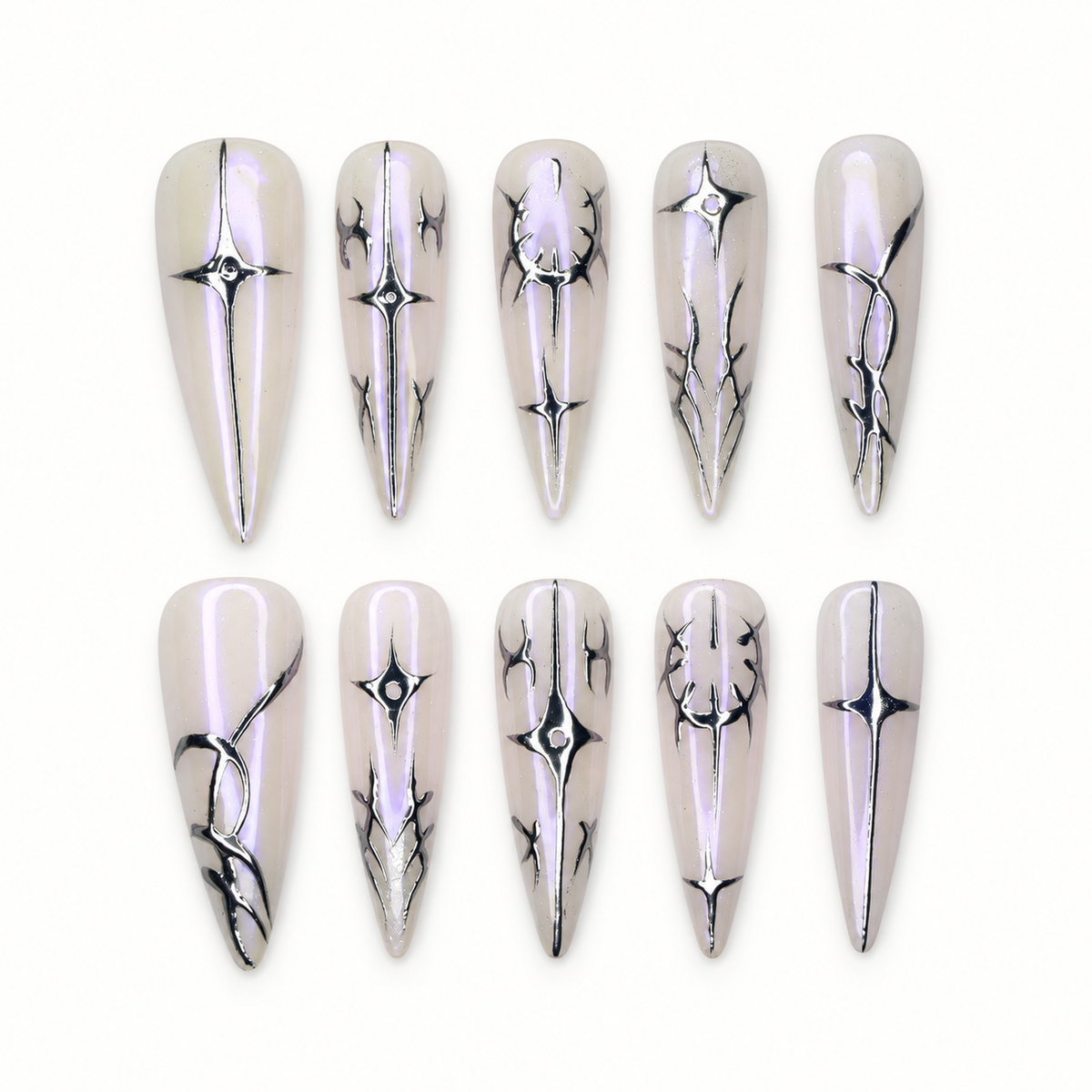 Ten pale greige-lilac press-on nails with silver starburst and thorn-like metallic linework arranged on a white tray.