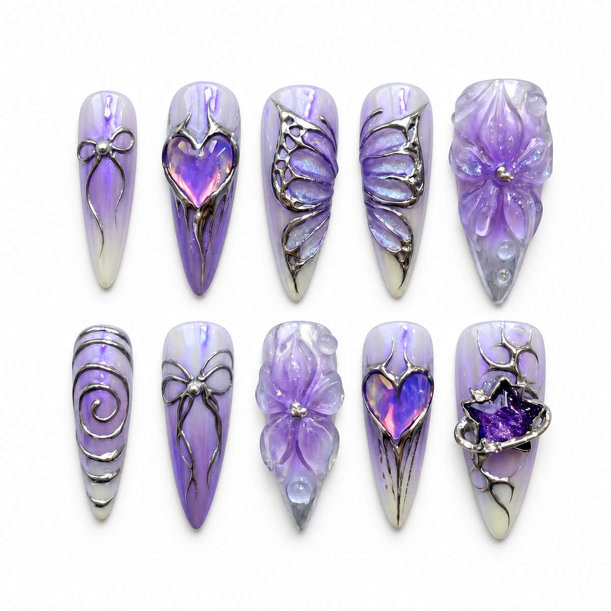 Ten Lavender Orbit press-on nails arranged on a pale background, showing violet marbling, raised petals, silver-toned linework, hearts, and celestial-inspired accents.