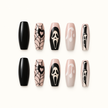 Webbed Noir press-on nail set with black spiderweb artwork, nude and blush bases, black tips, and skull-like accent art