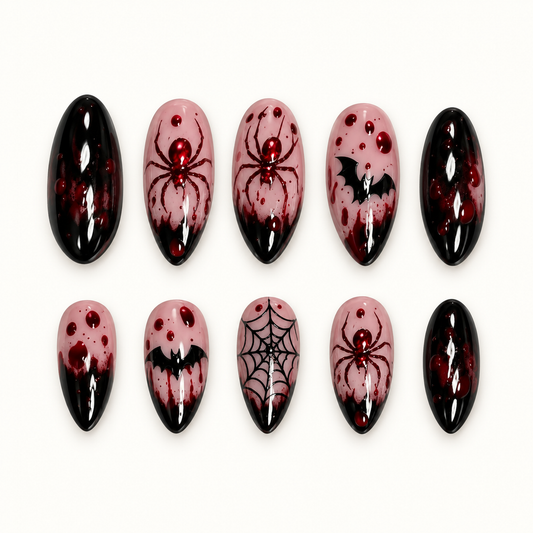 Crimson Web press-on nail set with glossy black tips, burgundy splatter, spiders, bats, and web nail art.