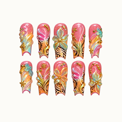 Ten coral-pink and peach nails arranged in two rows on a light neutral background, with raised flowers, aqua swirls, black patterns, and gold-toned starfish accents.