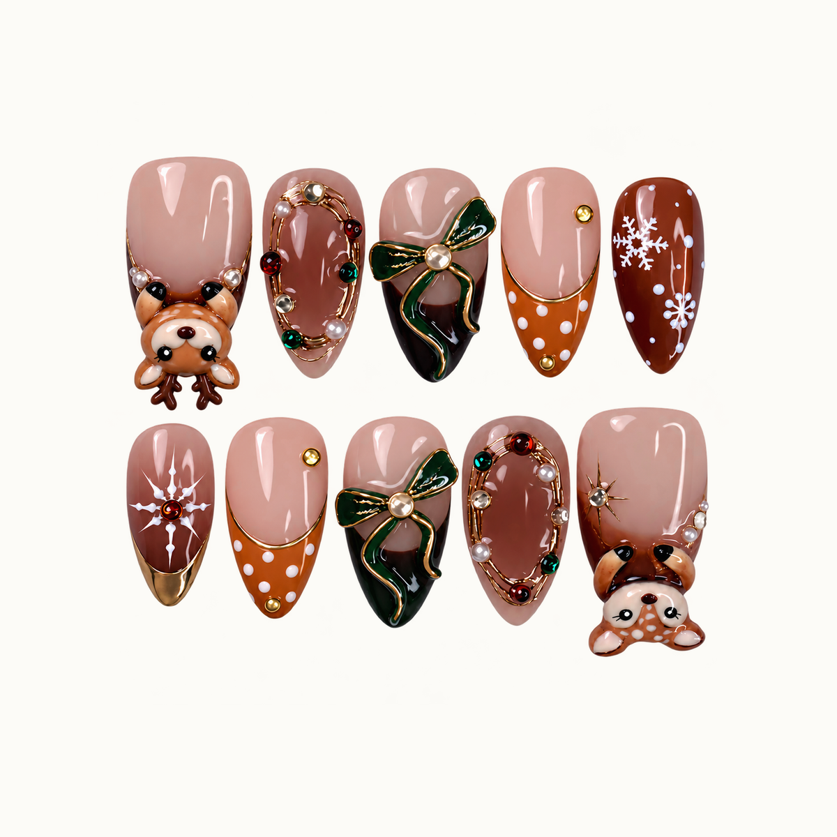 Ten glossy blush and brown nails arranged in two rows, featuring raised reindeer, green bows, snowflakes, and gold-toned jeweled borders.