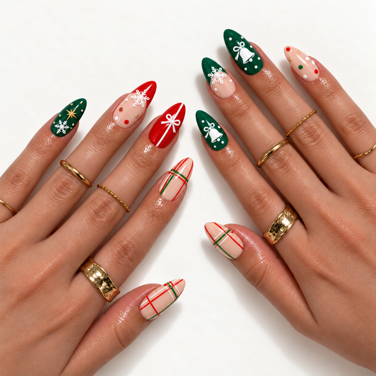 Hand model mockup showing pointed Christmas nails with red and evergreen accents, peachy nude plaid, white snowflakes, bows, and bell motifs.