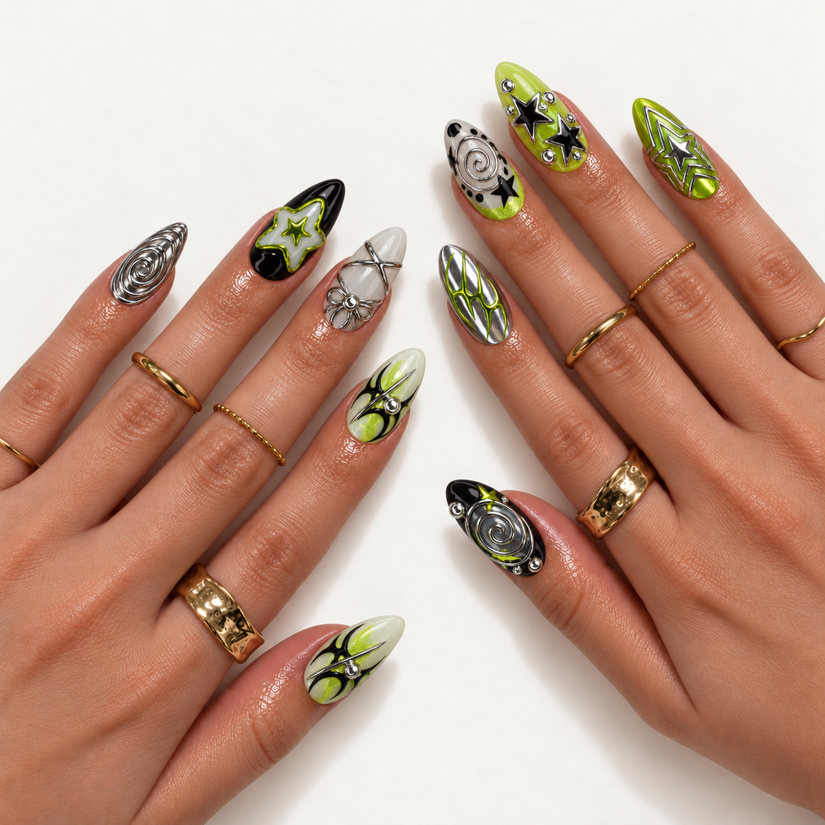 Hand model mockup showing lime, black, and silver-toned star and spiral nail designs with gold-toned rings.