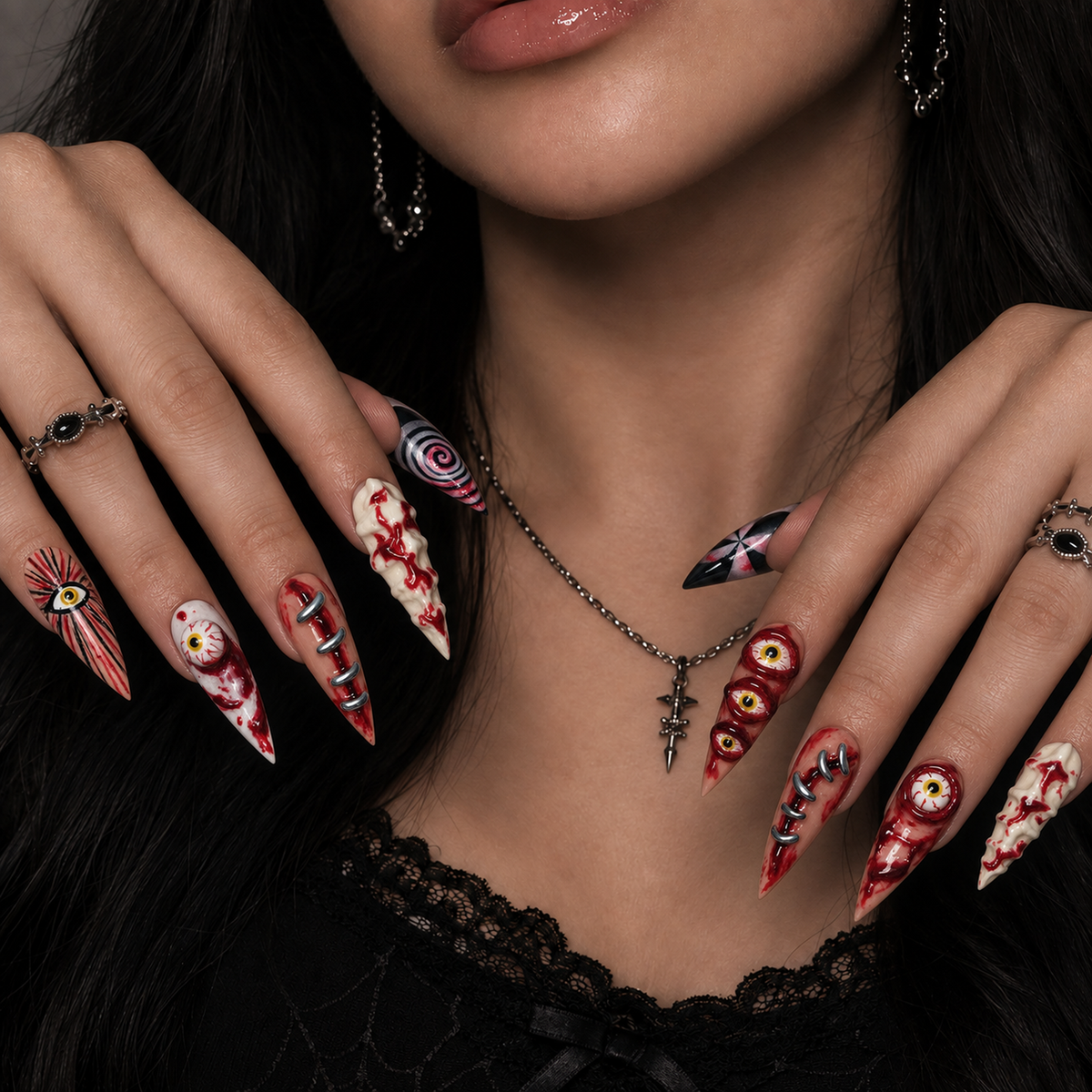 Hand model wearing Bloodshot Stitches press-on nails with eerie eye art, crimson detailing, and dark graphic accents.