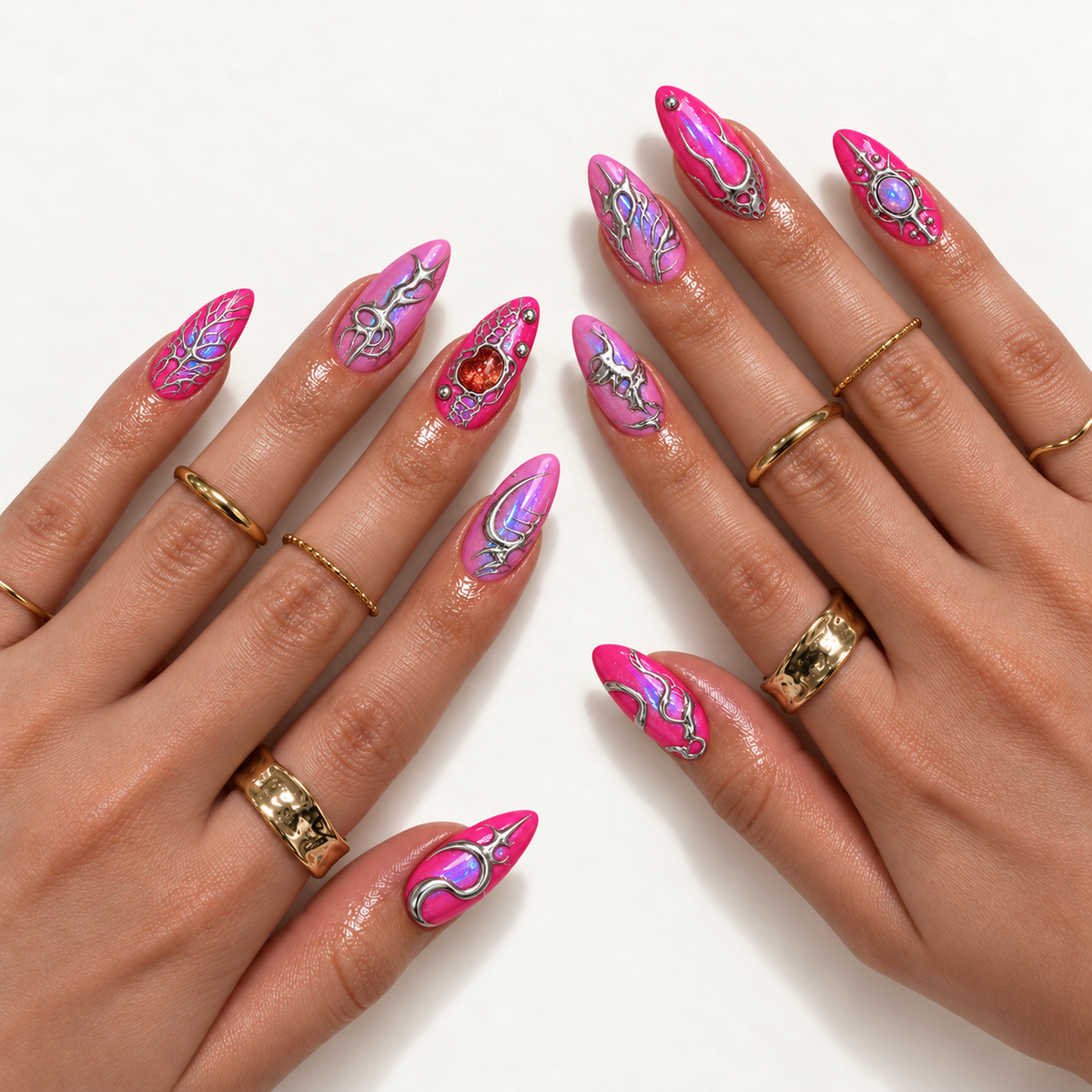 Hand model mockup showing pink nails with silver-toned ornamentation, blue-violet shimmer, and jewel-like accents, styled with gold-toned rings.