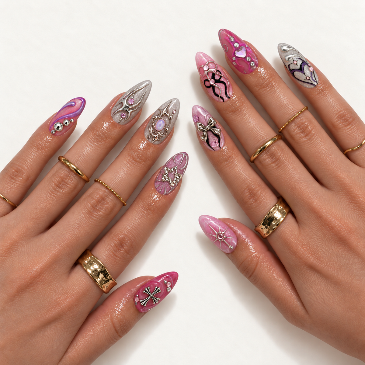 Hand model mockup showing the pink and silver nail design on two hands, with varied celestial, bow, cross, and gem details alongside gold-colored rings.