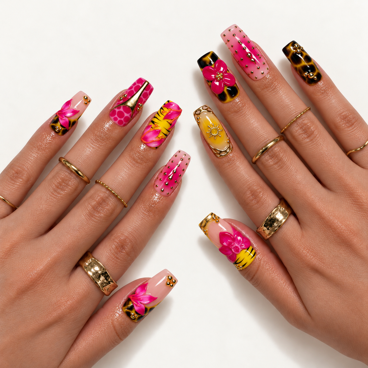 Hand model mockup showing pink floral and animal-pattern nails with yellow, blush, and gold-toned details, styled with gold-toned rings.