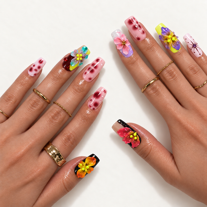 Hand model mockup displaying colorful raised floral nails, pink spotted accents, glossy droplets, and a pink starburst design with gold-tone rings.