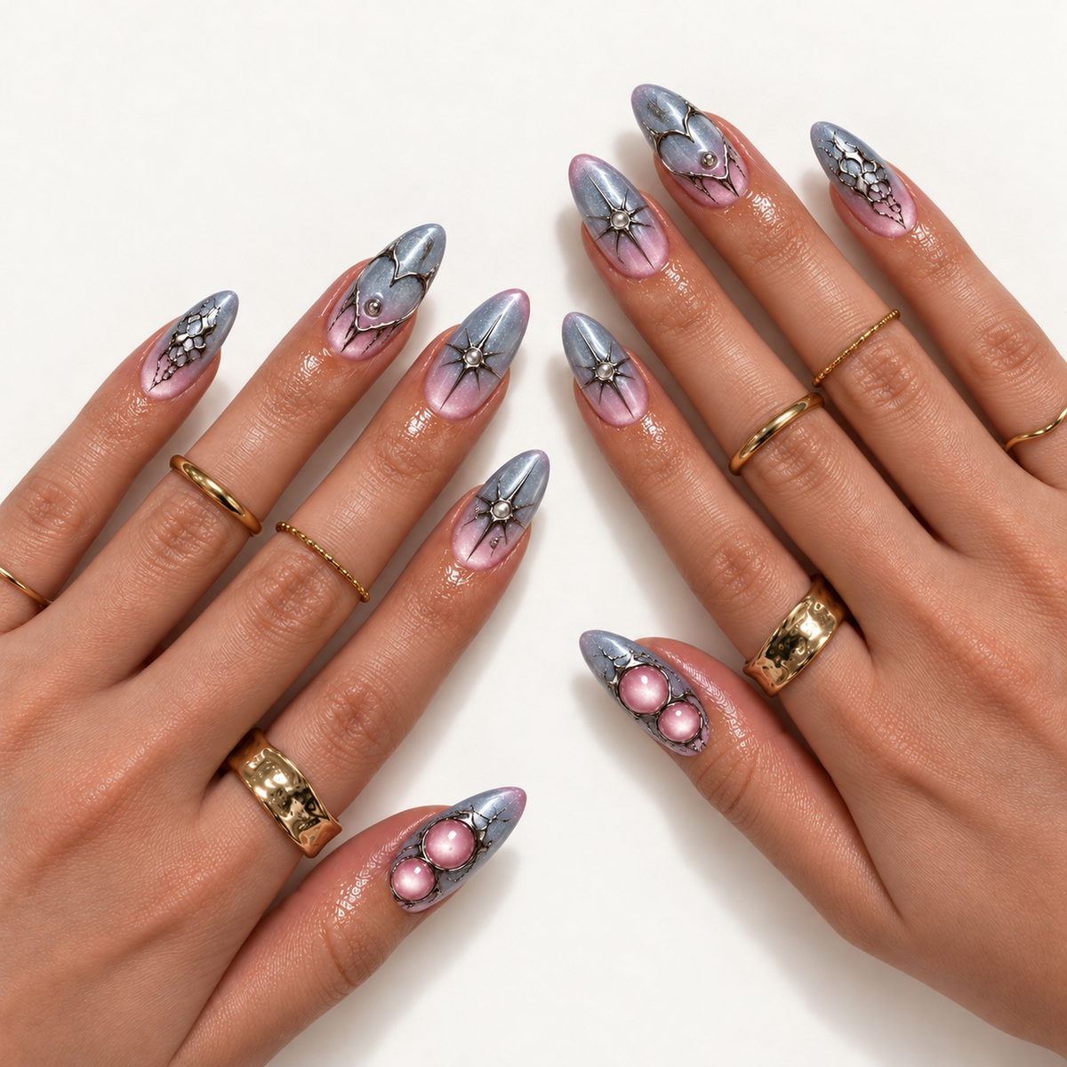 Hand model mockup showing silver-gray and pink gradient nails with heart outlines, starbursts, web-like accents, and pink details, styled with gold-tone rings.