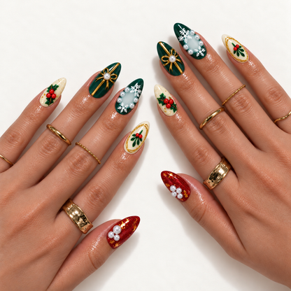 Hand model mockup showing Christmas nail art in green, red, and ivory with gold-tone bows, leafy berries, white snowflakes, and pearl-like accents, paired with gold-tone rings.