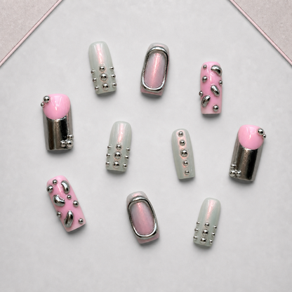 Chrome Petal press-on nail set displayed on the approved walnut tray, showing pink, sage, mauve, and silver chrome details.