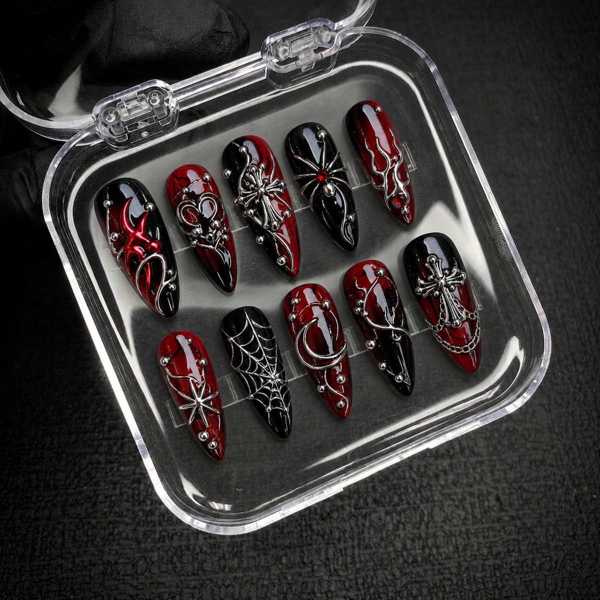 Open Nail Handy package box showing the Crimson Web Relic press-on nail set and included presentation materials.