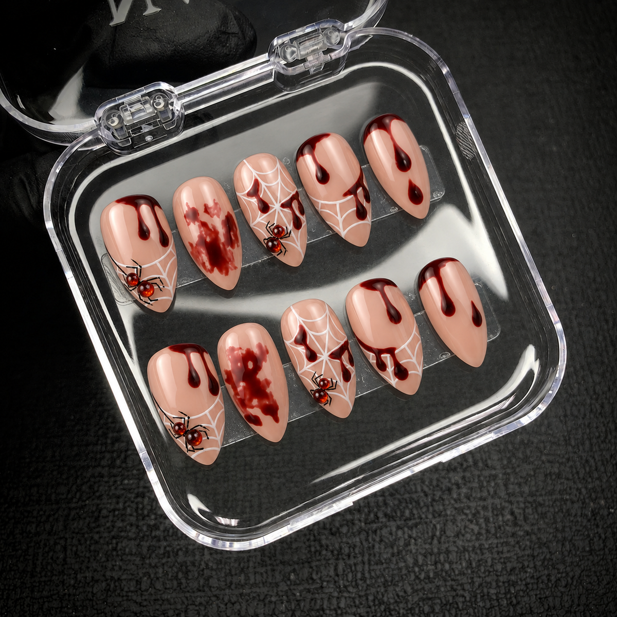 Open Nail Handy package displaying the Crimson Web Drip press-on nail set and its coordinated contents.