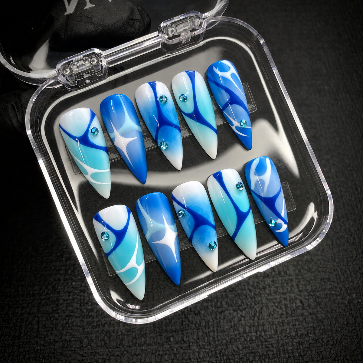 Blue Current press-on nail set displayed with Nail Handy packaging open.