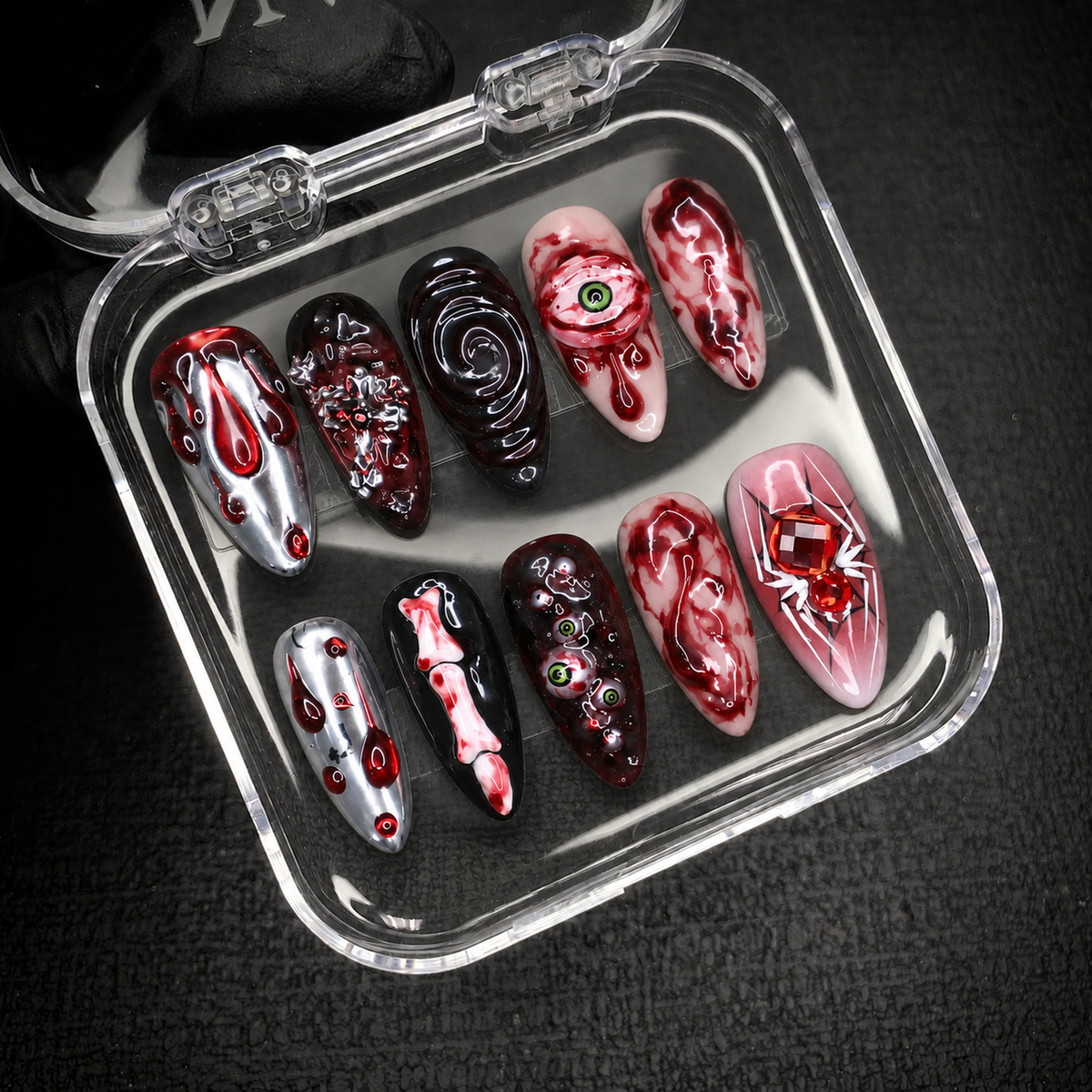 Open Nail Handy package box displaying the Crimson Eyeball press-on nail set and included presentation materials.