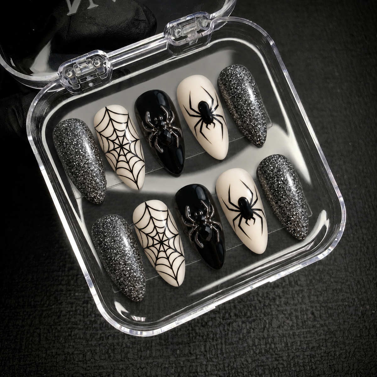Silver Web Spider press-on nail set displayed with Nail Handy branded packaging open.