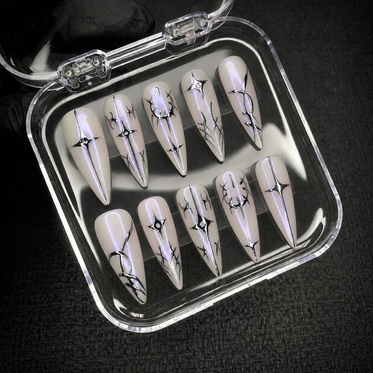 Open Nail Handy package displaying the Chrome Thorn Starlight press-on nail set.