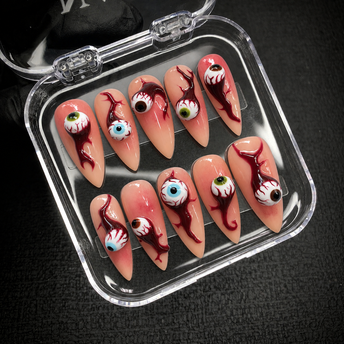 Open Nail Handy branded package displaying the Bloodshot Gaze press-on nail set and its included contents.