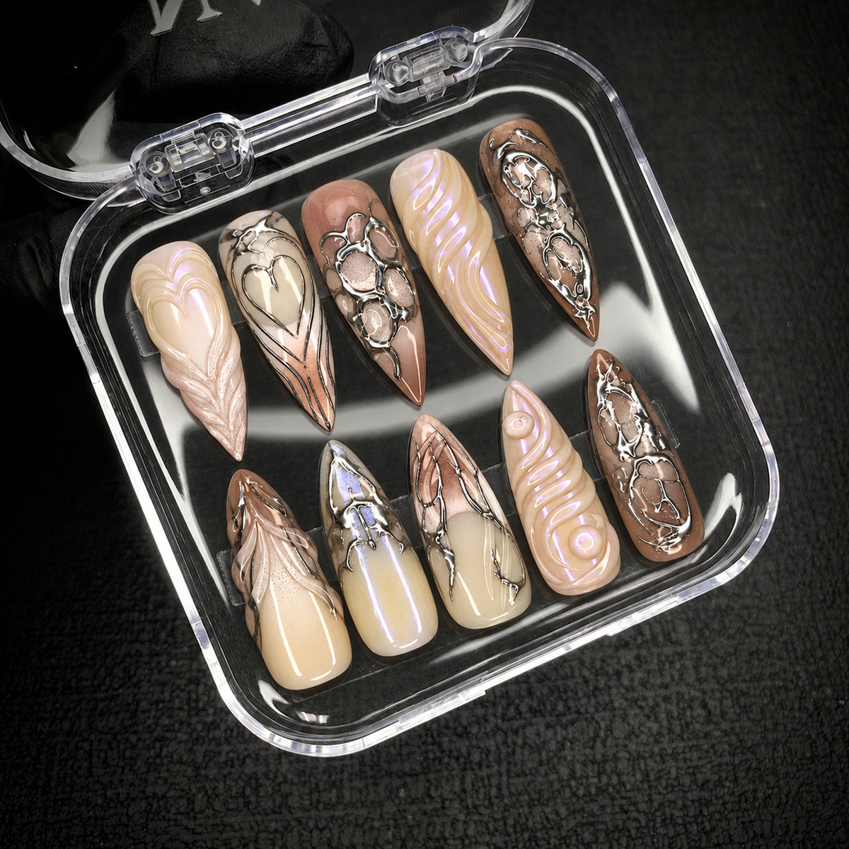 Open Nail Handy package box displaying the Chrome Relic press-on nail set and included presentation materials.
