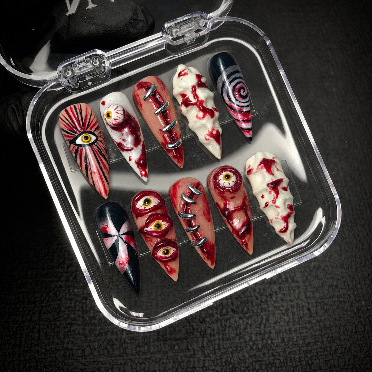 Open Nail Handy package displaying the Bloodshot Stitches press-on nail set and included order contents.