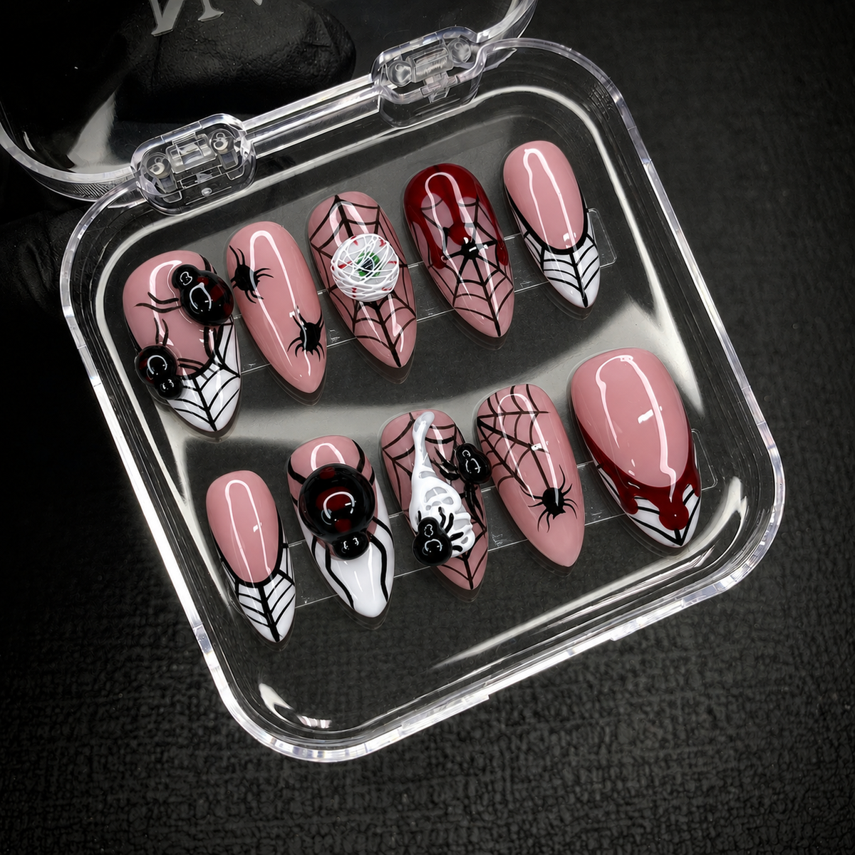 Open Nail Handy package box with Crimson Web Crawl press-on nail set and included contents.