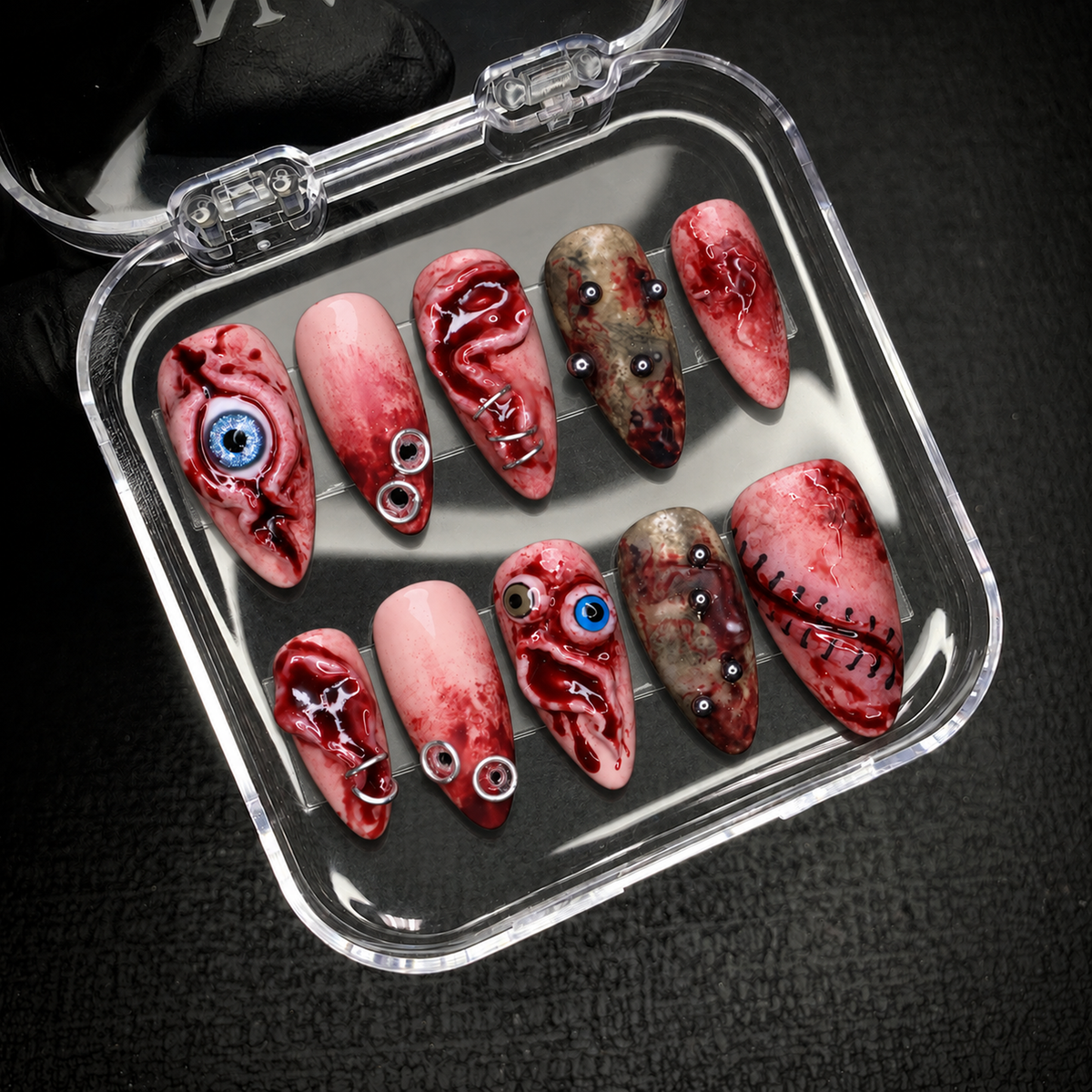 Open Nail Handy package displaying the Bloodshot Gaze press-on nail set and included contents.
