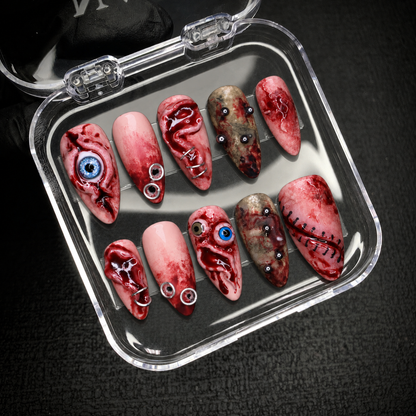 Open Nail Handy package displaying the Bloodshot Gaze press-on nail set and included contents.