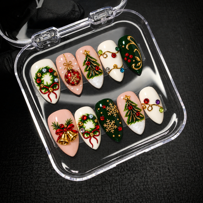 Open clear case holding ten coordinated Christmas press-on nails in two rows against a dark textured background.