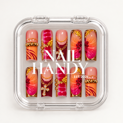 Closed clear Nail Handy case displaying ten coordinated floral and charm-accented nails beneath white lid lettering.