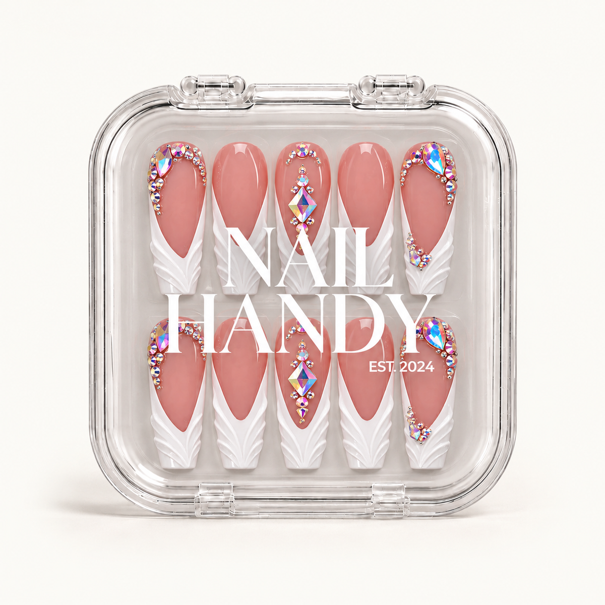 Closed clear Nail Handy case displaying ten dusty rose and white nails with sculpted tips and iridescent gem accents against a light background.