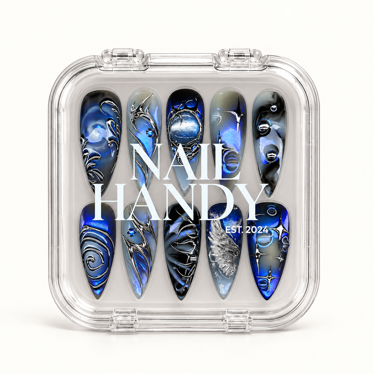Closed clear Nail Handy case displaying ten blue, gray, and black nails beneath white branding, with silver starbursts, spirals, and wing artwork.