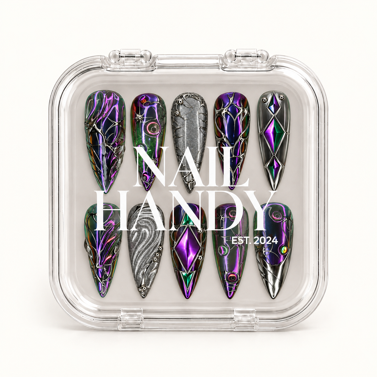 Closed clear Nail Handy case displaying ten dark prismatic nails with silver-toned ornament, purple and green diamond motifs, and silver-gray accents.