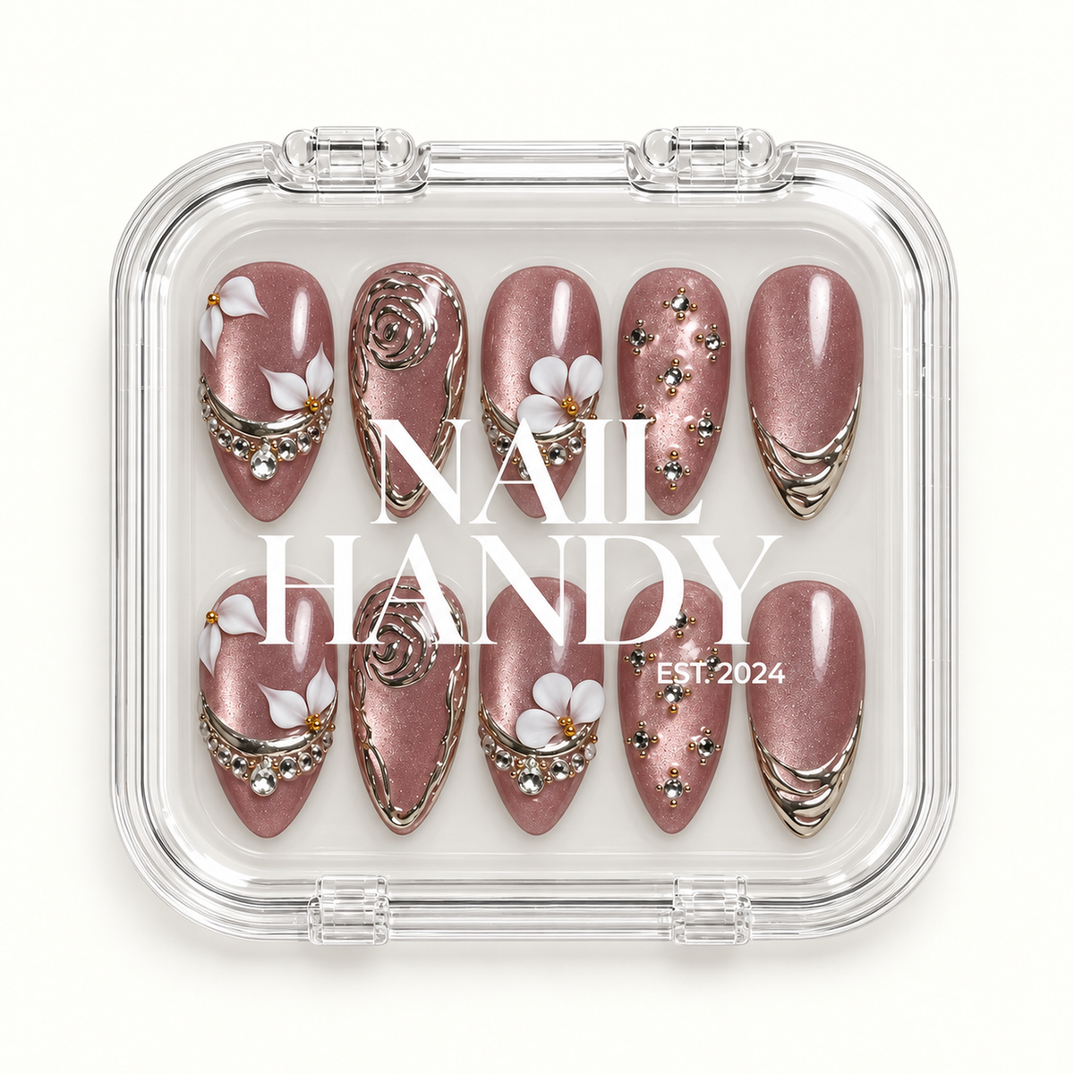 Closed clear Nail Handy case displaying ten mauve shimmer nails in two rows, with white floral accents, silver-toned ornament, and gem details.