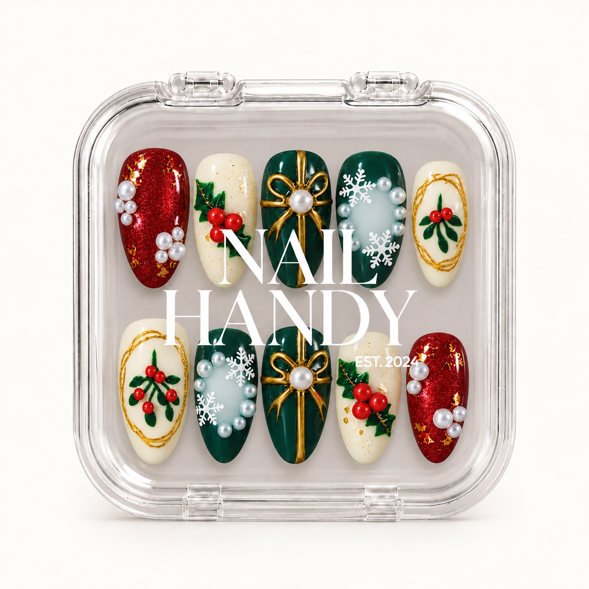 Closed clear Nail Handy case displaying ten green, red, and ivory Christmas nails beneath white branding, with gold-tone bows, leafy berries, and snowflake accents.