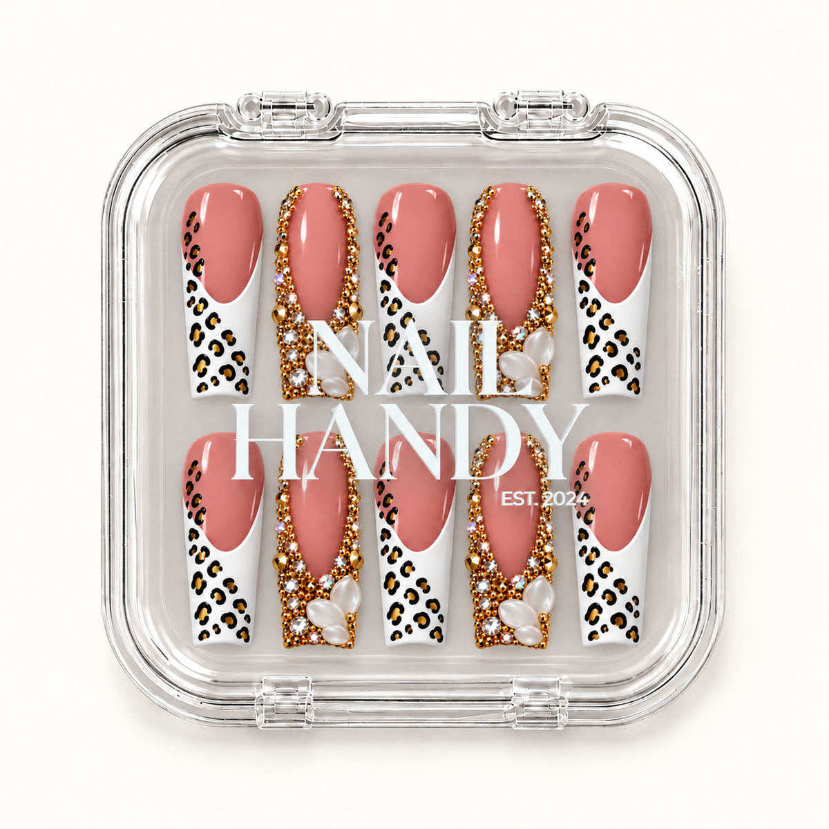 Closed clear Nail Handy case displaying ten blush pink nails with white leopard-print tips, gold-tone embellishments, and pearl-like clusters.