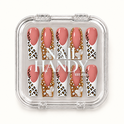 Closed clear Nail Handy case displaying ten blush pink nails with white leopard-print tips, gold-tone embellishments, and pearl-like clusters.